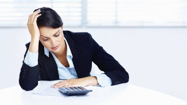 Tense business woman looking at branding costs